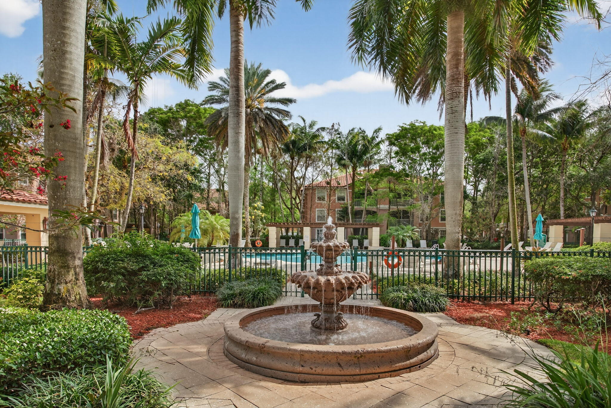 6890 West Sample Road, Unit 6890 Pompano Beach, FL 33063 - Photo 21 of 36 a view of a fountain with a house in the background