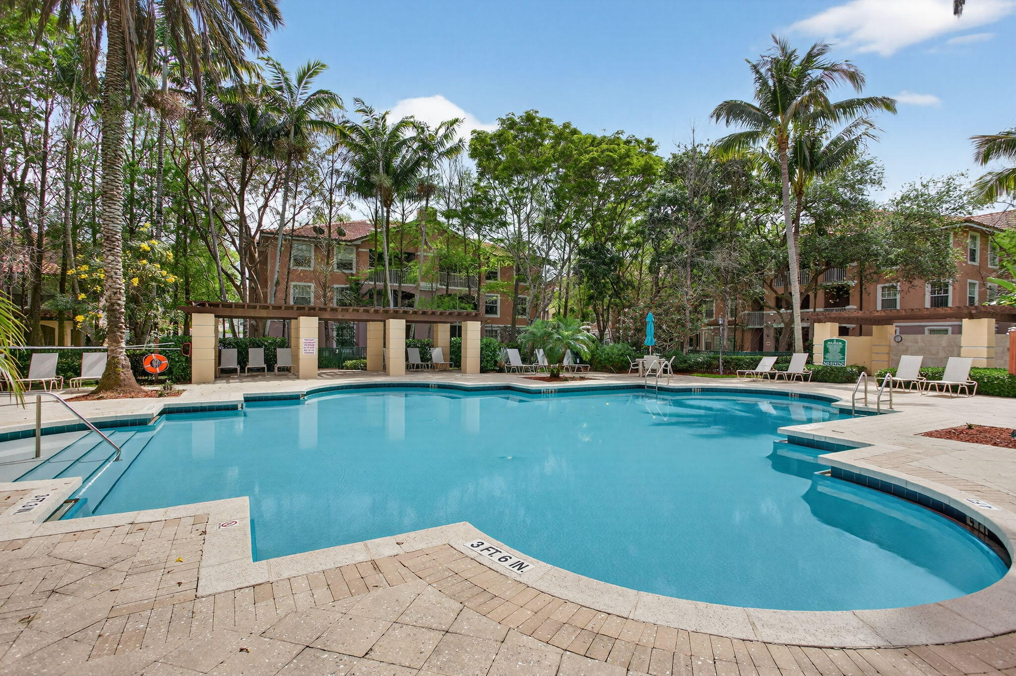 6890 West Sample Road, Unit 6890 Pompano Beach, FL 33063 - Photo 22 of 36 a view of a swimming pool with a patio