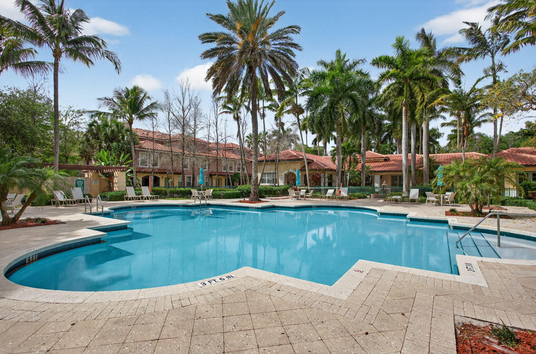 6890 West Sample Road, Unit 6890 Pompano Beach, FL 33063 - Photo 25 of 36 a view of a swimming pool and lounge chair