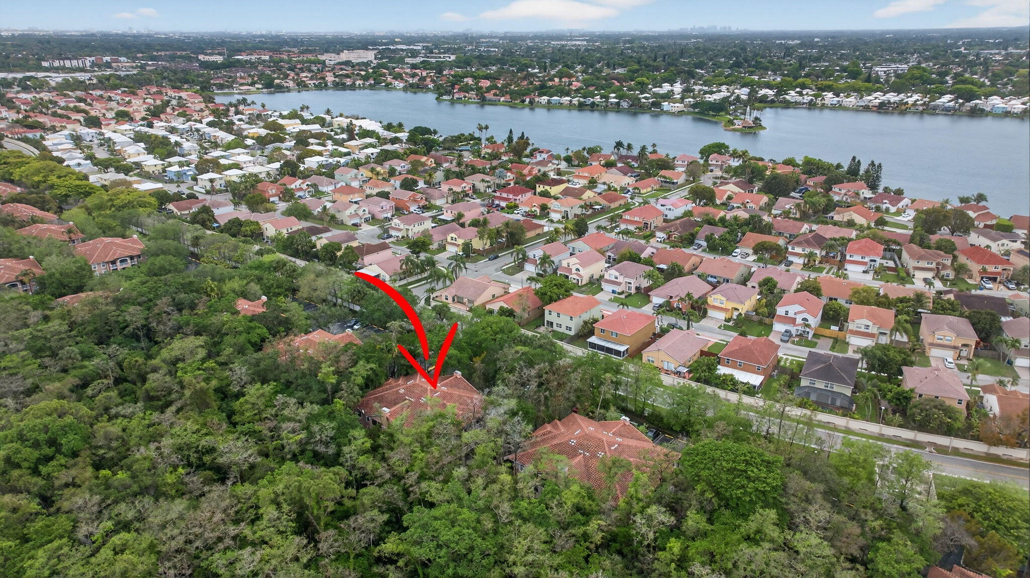 6890 West Sample Road, Unit 6890 Pompano Beach, FL 33063 - Photo 30 of 36 an aerial view of city and lake with trees