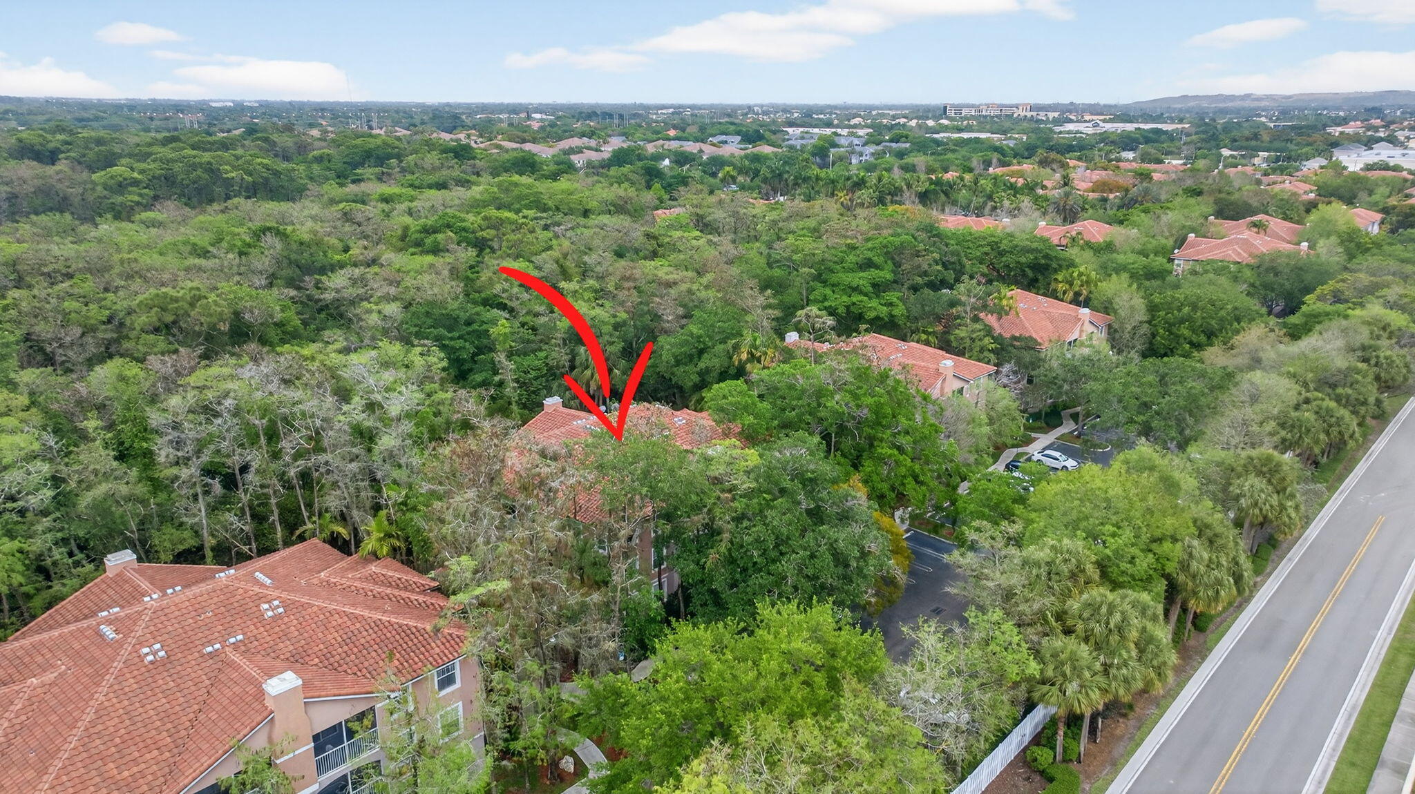 6890 West Sample Road, Unit 6890 Pompano Beach, FL 33063 - Photo 36 of 36 an aerial view of a houses with a lush green hillside