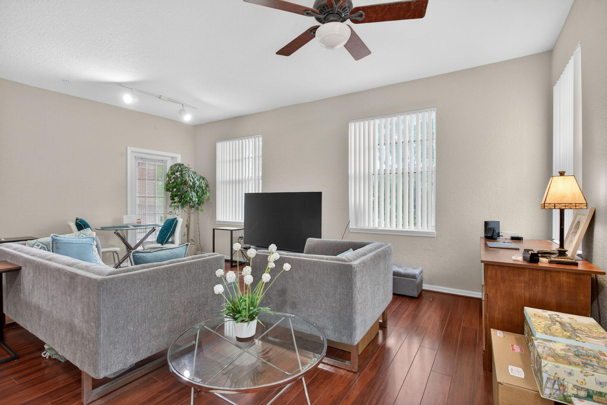 6890 West Sample Road, Unit 6890 Pompano Beach, FL 33063 - Photo 4 of 36 a living room with furniture a large window and a wooden floor