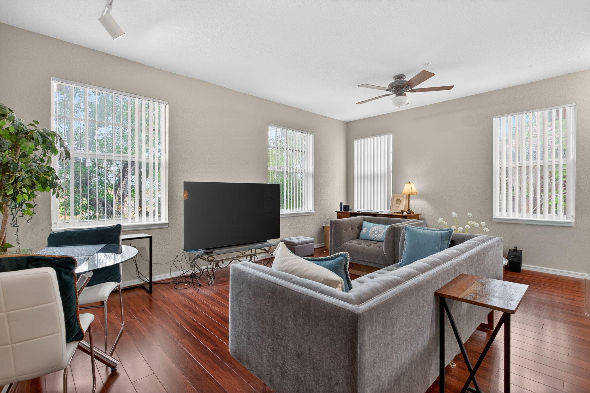 6890 West Sample Road, Unit 6890 Pompano Beach, FL 33063 - Photo 7 of 36 a living room with furniture a window and a flat screen tv