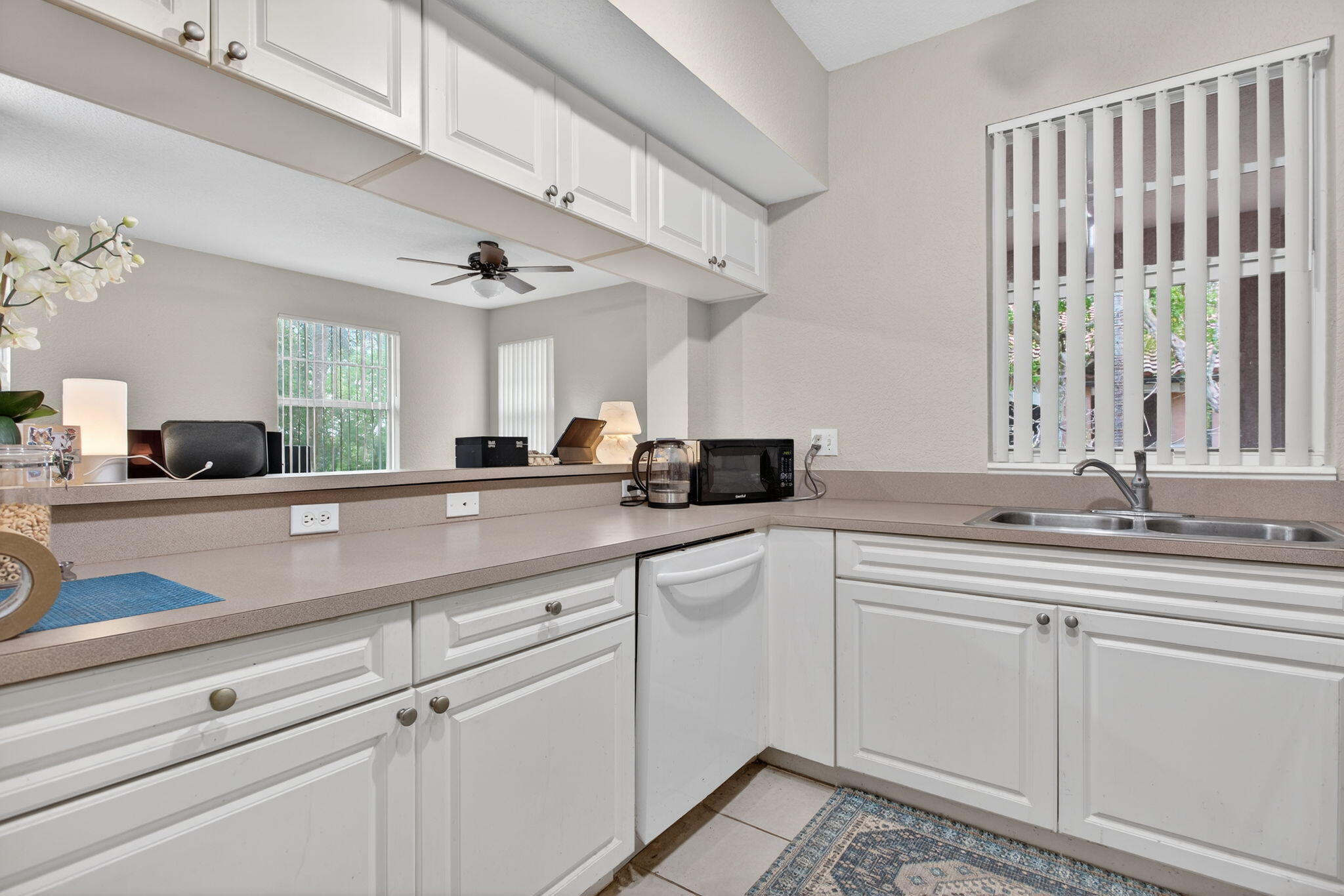 6890 West Sample Road, Unit 6890 Pompano Beach, FL 33063 - Photo 9 of 36 a kitchen with a sink and cabinets
