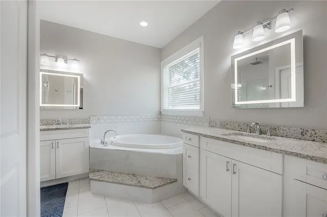 a bathroom with a sink toilet vanity and tub