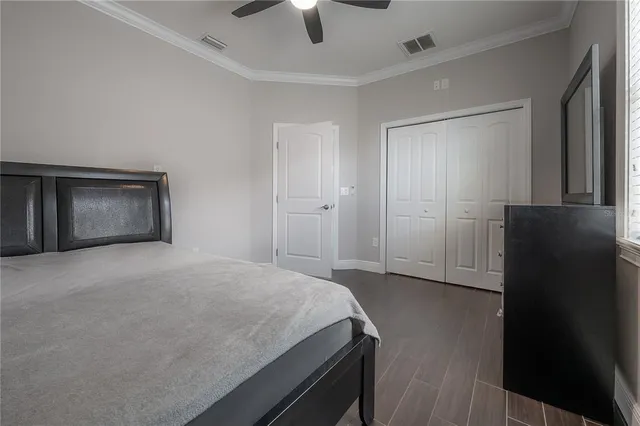 a bedroom with a bed and a ceiling fan