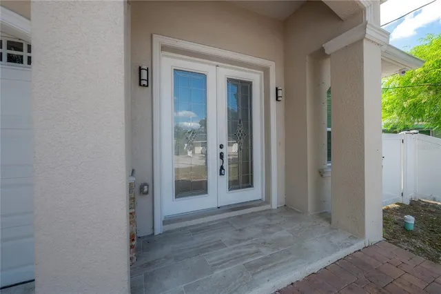 a view of a hallway with wooden floor and a bathroom