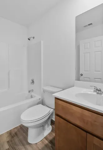 a bathroom with a sink a toilet and bathtub