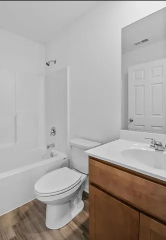 a bathroom with a sink a toilet and bathtub