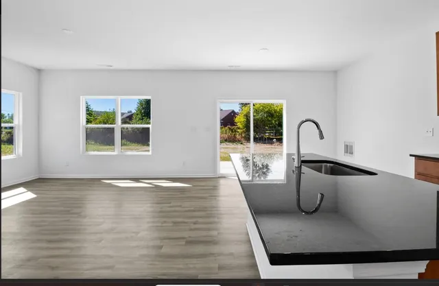 a view of living room filled with furniture and window