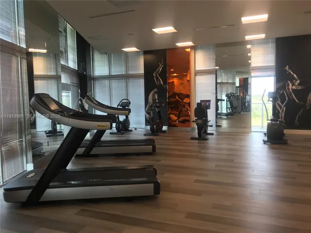 a lobby with furniture and floor to ceiling window