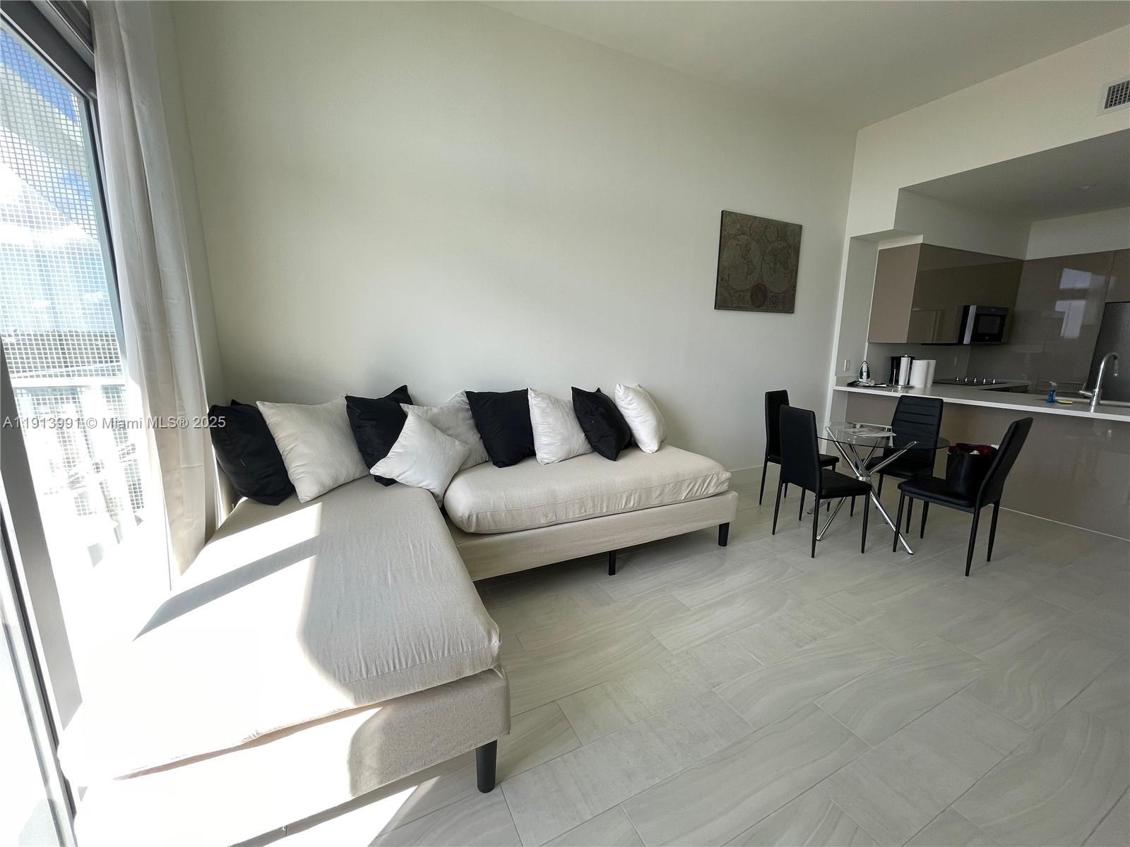 2000 Metropica Way, Unit 605 Sunrise, FL 33323 - Photo 20 of 24 a living room with furniture and a flat screen tv