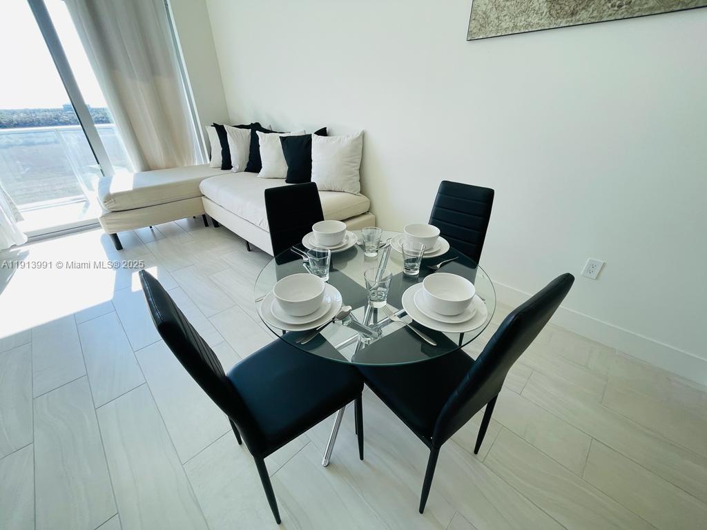 2000 Metropica Way, Unit 605 Sunrise, FL 33323 - Photo 2 of 24 a dining room with furniture and wooden floor