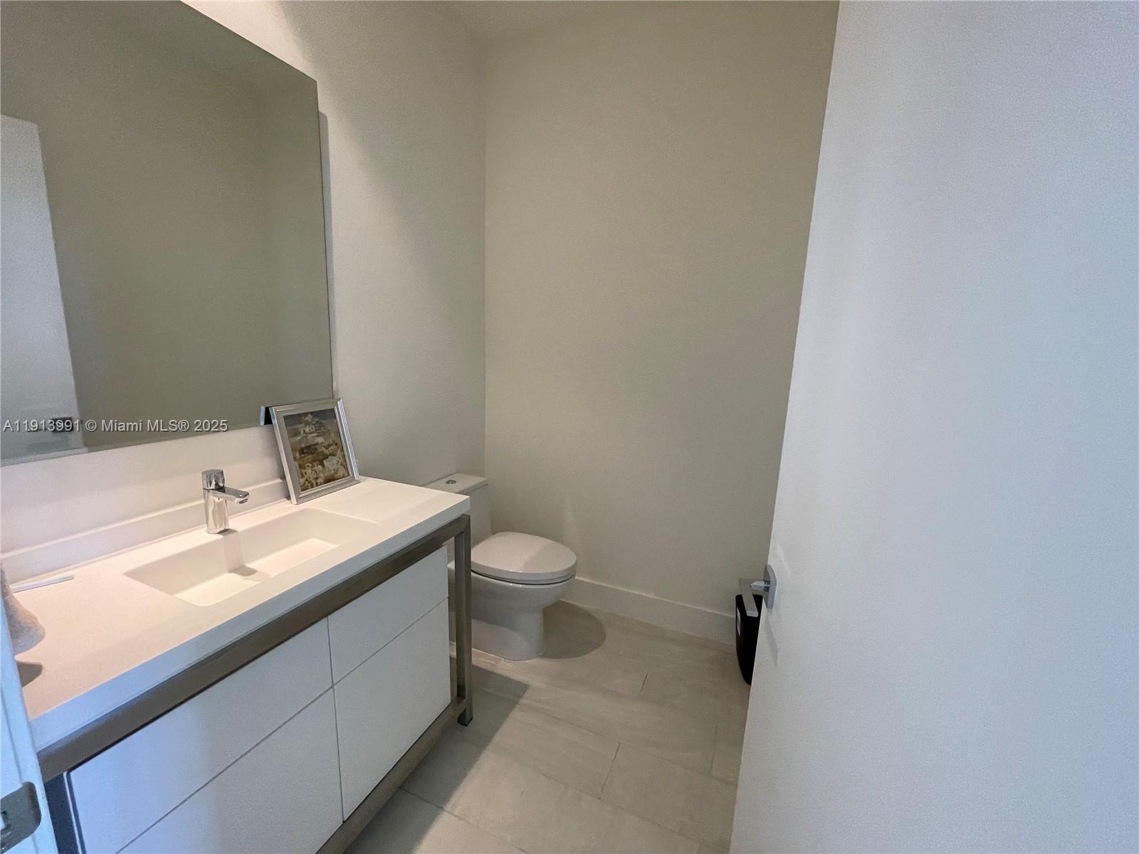 2000 Metropica Way, Unit 605 Sunrise, FL 33323 - Photo 22 of 24 a bathroom with a sink and a toilet