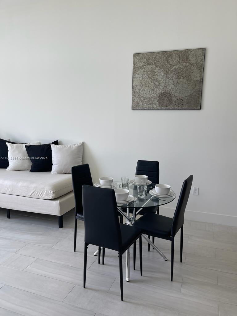 2000 Metropica Way, Unit 605 Sunrise, FL 33323 - Photo 3 of 24 a workspace with furniture and a wooden floor