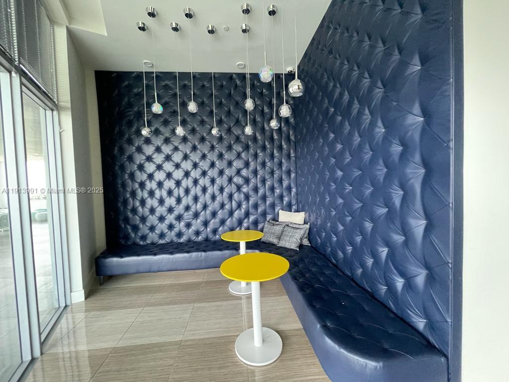 2000 Metropica Way, Unit 605 Sunrise, FL 33323 - Photo 4 of 24 a bathroom with a granite countertop sink and a mirror