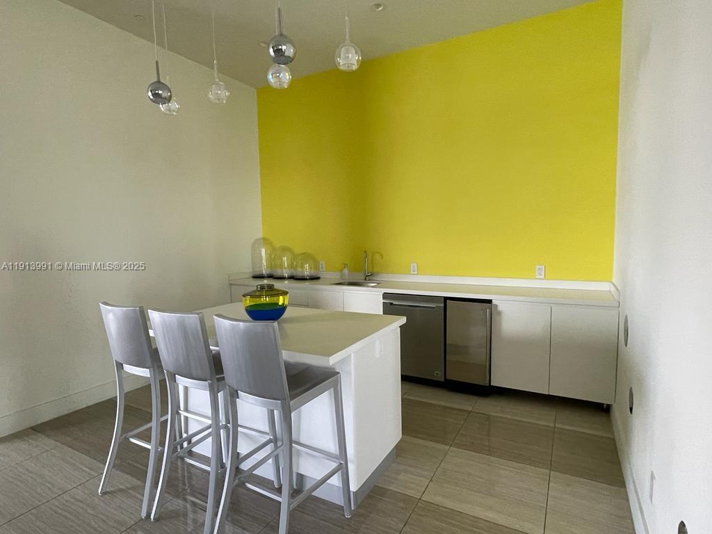 2000 Metropica Way, Unit 605 Sunrise, FL 33323 - Photo 5 of 24 a kitchen with a table and chairs