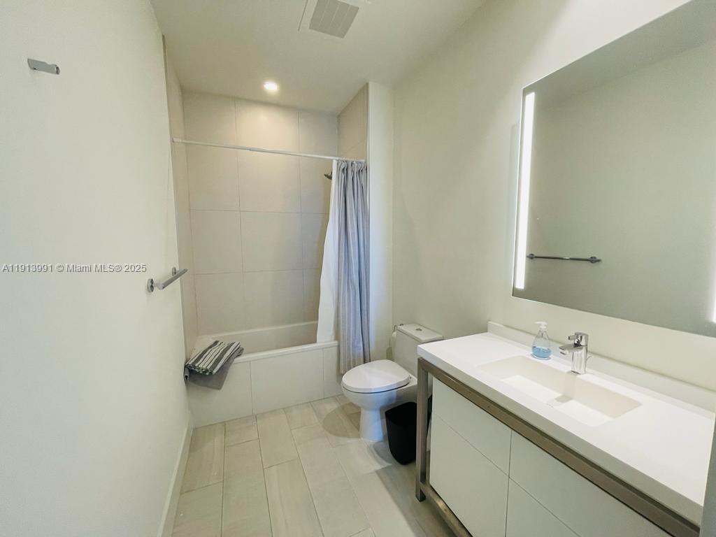 2000 Metropica Way, Unit 605 Sunrise, FL 33323 - Photo 6 of 24 a bathroom with a sink a toilet and shower