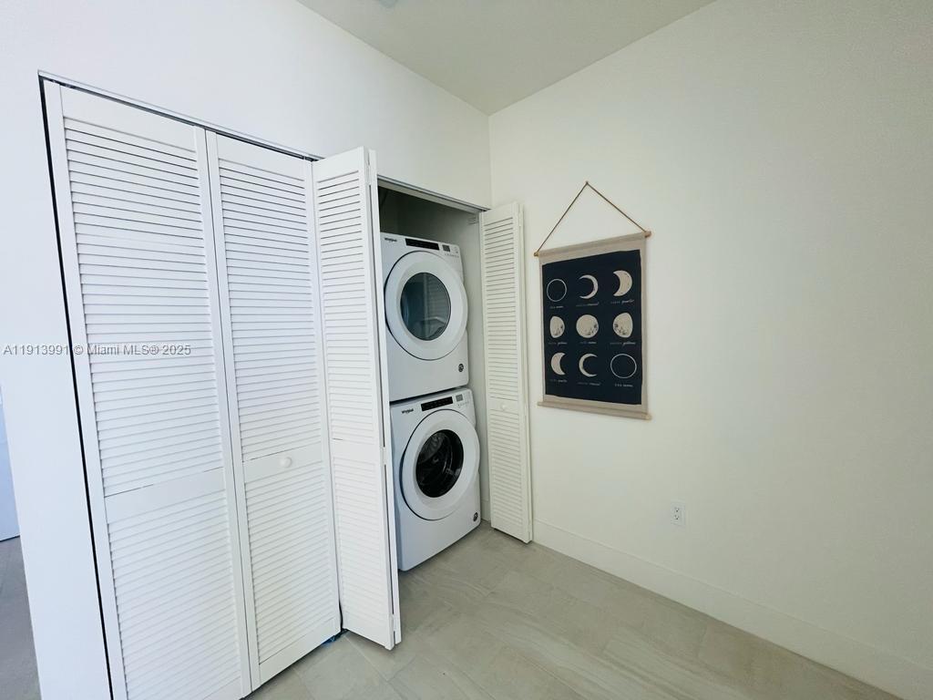 2000 Metropica Way, Unit 605 Sunrise, FL 33323 - Photo 7 of 24 a utility room with dryer and washer