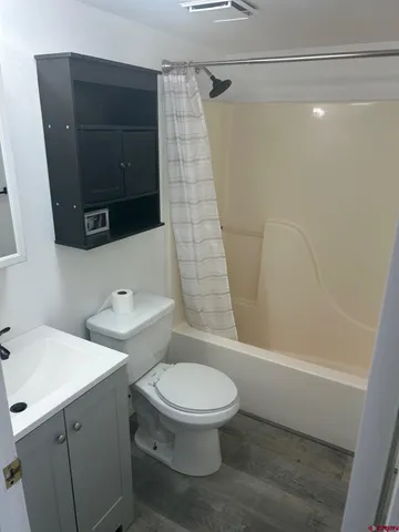 a white toilet sitting next to a bathroom sink