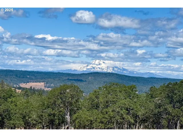 a view of a house with wooden fence