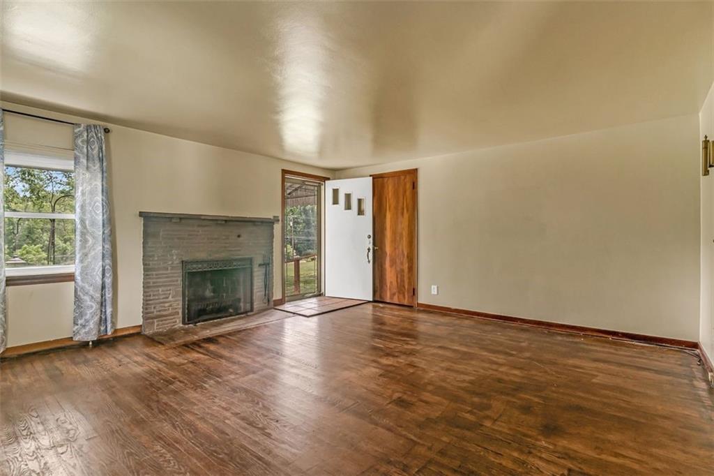 575 State Rte 908 Extension Tarentum, PA 15084 - Photo 4 of 32 an empty room with wooden floor fireplace and windows