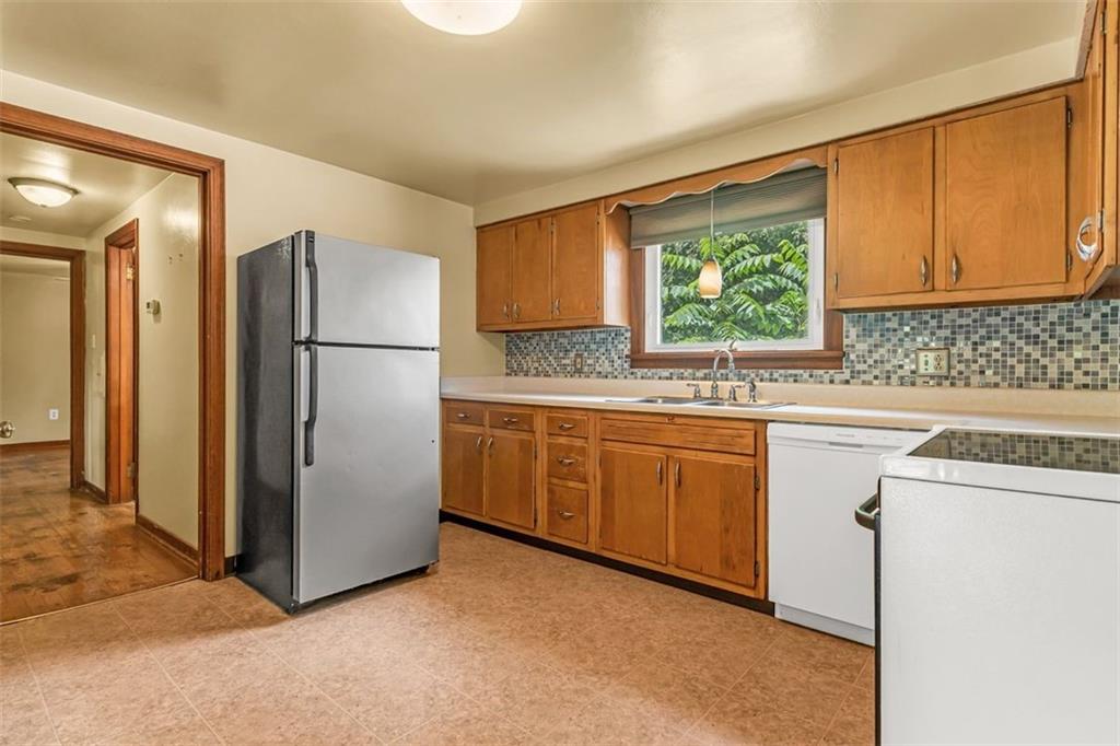575 State Rte 908 Extension Tarentum, PA 15084 - Photo 8 of 32 a kitchen with sink refrigerator and cabinets