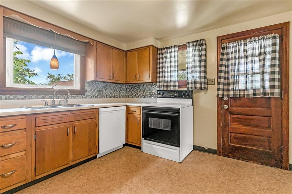 575 State Rte 908 Extension Tarentum, PA 15084 - Photo 9 of 32 a kitchen with stainless steel appliances granite countertop a stove a sink and a microwave