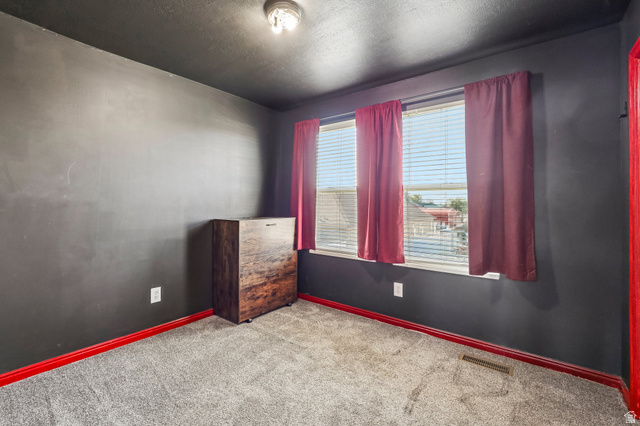 3215 West 450 North West Point, UT 84015 - Photo 19 of 40 Room featuring dark gray walls, a gray carpeted floor, and red trim