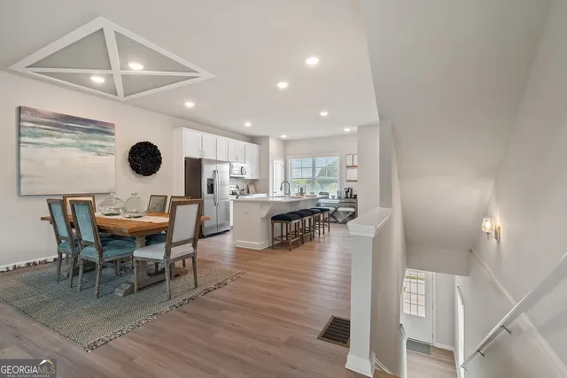 a view of a dining room with furniture and wooden floor