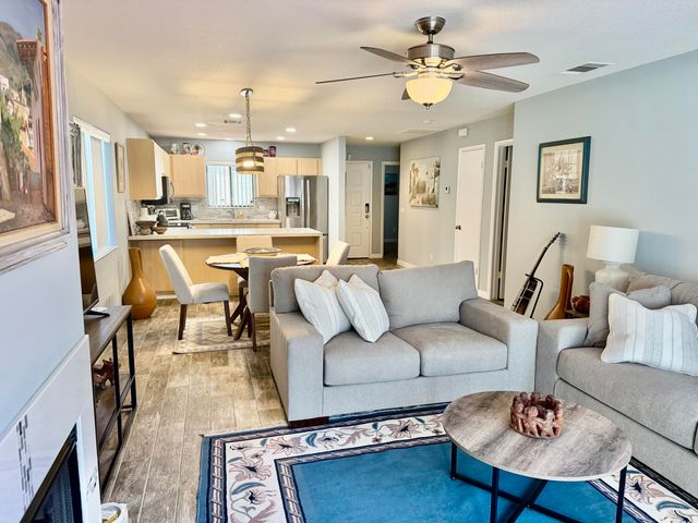a living room with furniture or kitchen view and a chandelier