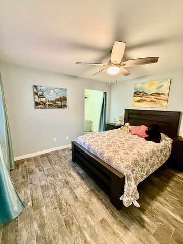a bedroom with a bed and a painting on the wall