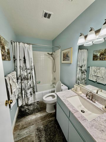 a bathroom with a double vanity sink toilet and shower