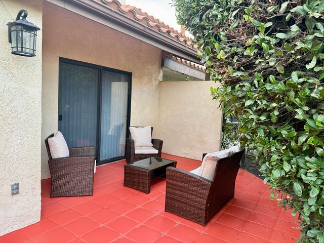 a outdoor space with patio couches and a potted plant