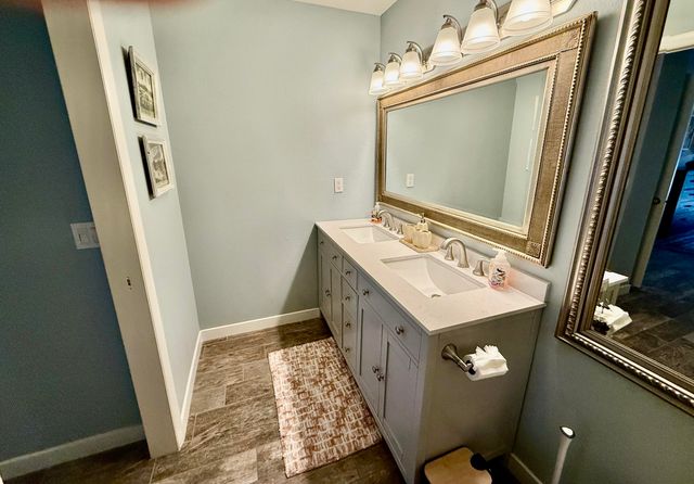 a bathroom with a sink a mirror and vanity
