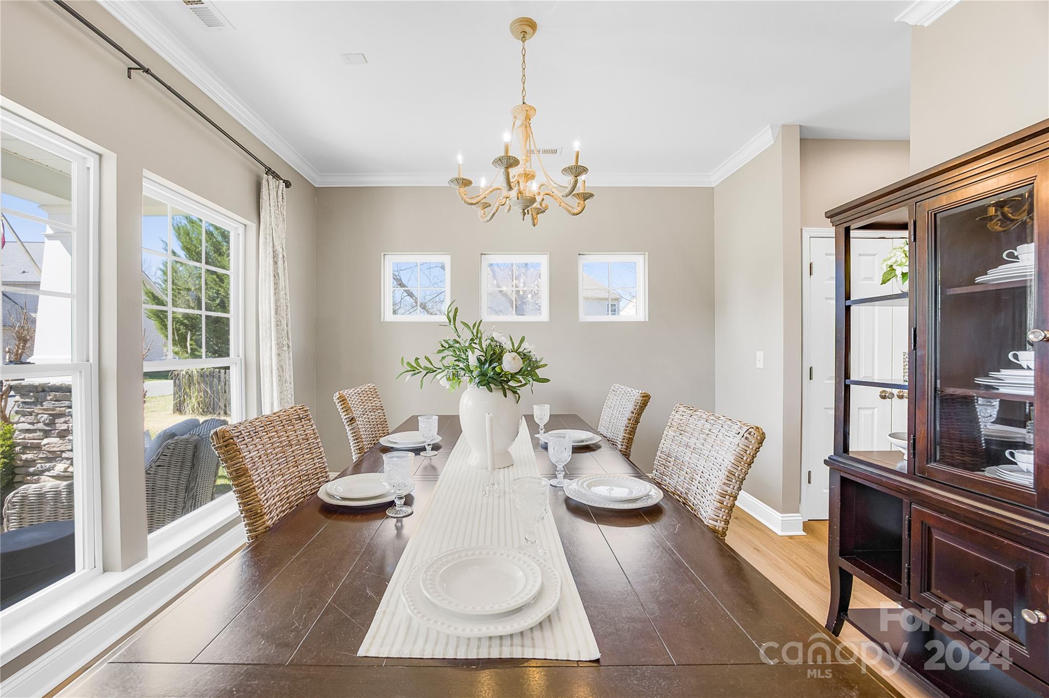 1003 Sipes Place Indian Trail, NC 28079 - Photo 13 of 45 a living room with furniture a chandelier and a table