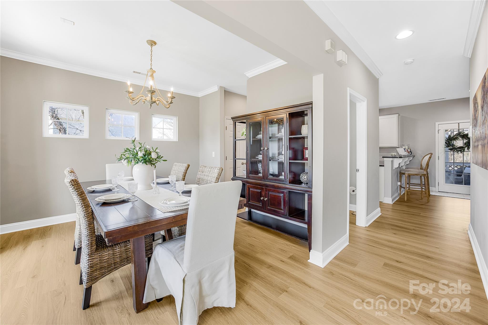 1003 Sipes Place Indian Trail, NC 28079 - Photo 15 of 45 a view of a dining room with furniture and wooden floor