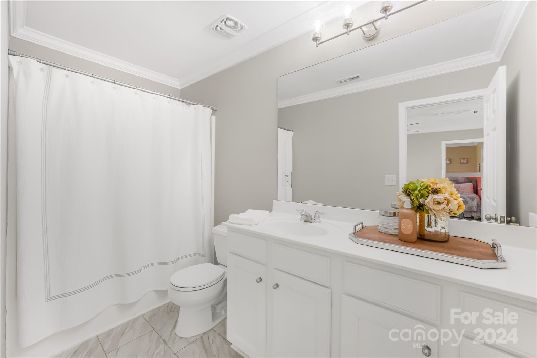 1003 Sipes Place Indian Trail, NC 28079 - Photo 34 of 45 a bathroom with a granite countertop sink a toilet and a mirror