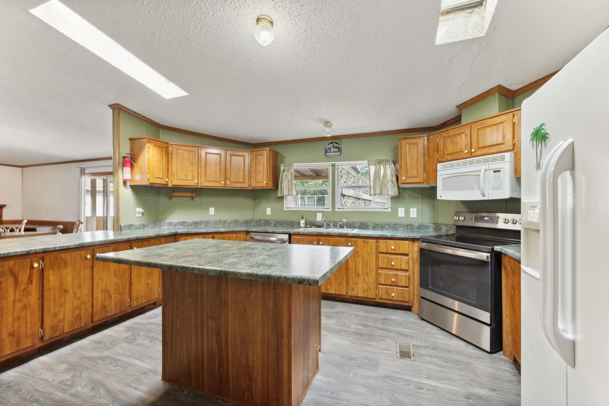 3270 Rocky Valley Road Lebanon, TN 37090 - Photo 13 of 55 a kitchen with stainless steel appliances granite countertop wooden cabinets a sink dishwasher a stove and a refrigerator