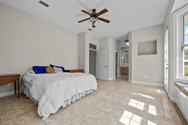 a bed room with a bed and a chandelier