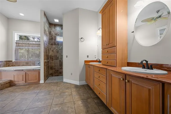 a spacious bathroom with a double vanity sink and a mirror
