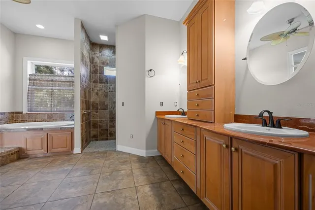 a spacious bathroom with a double vanity sink and a mirror
