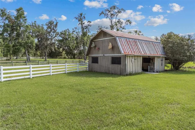 a front view of a house with a garden and yard