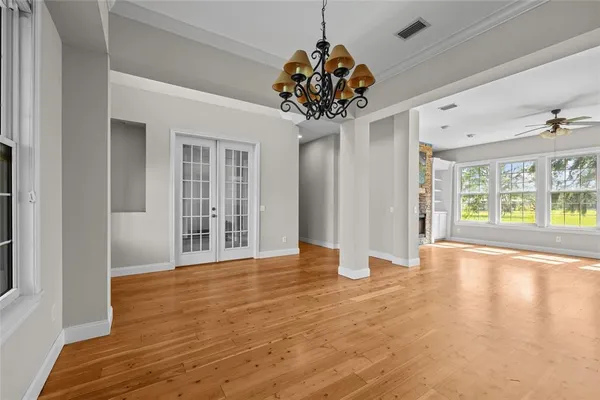 a view of an empty room with a chandelier