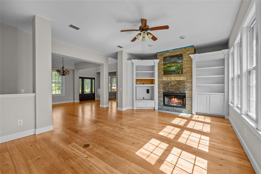 10852 89th Road Live Oak, FL 32060 - Photo 5 of 40 a view of an empty room with wooden floor and a window