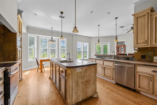 a kitchen with counter and wooden floor