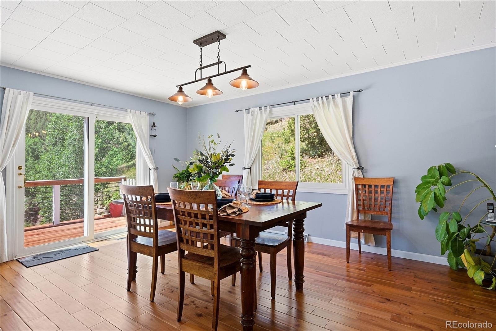 427 Brookside Drive Bailey, CO 80421 - Photo 17 of 37 a view of a dining room with furniture window and wooden floor