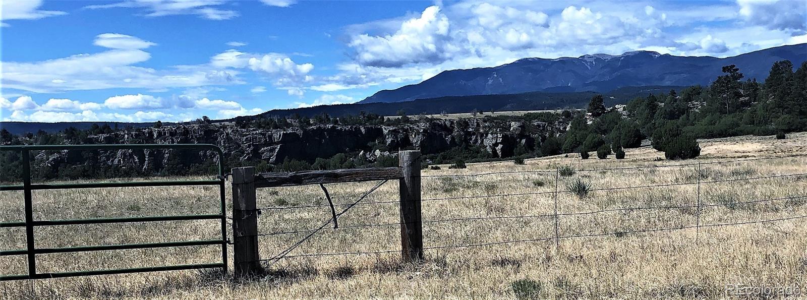 a view of wooden fence and a yard