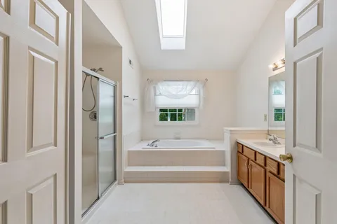 a kitchen with stainless steel appliances granite countertop wooden cabinets a sink and dishwasher a stove with wooden floor