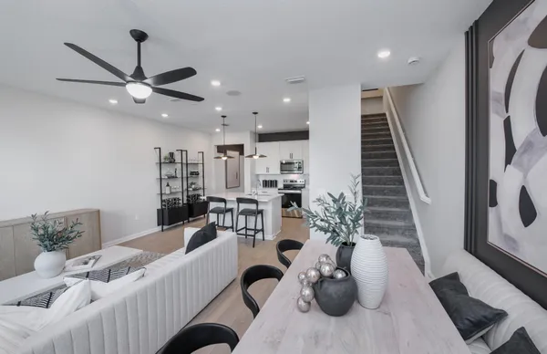 a living room with furniture potted plant and a chandelier